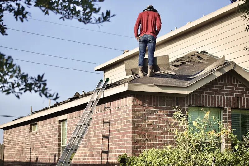 Professional roofer working on a residential roof in Long Beach